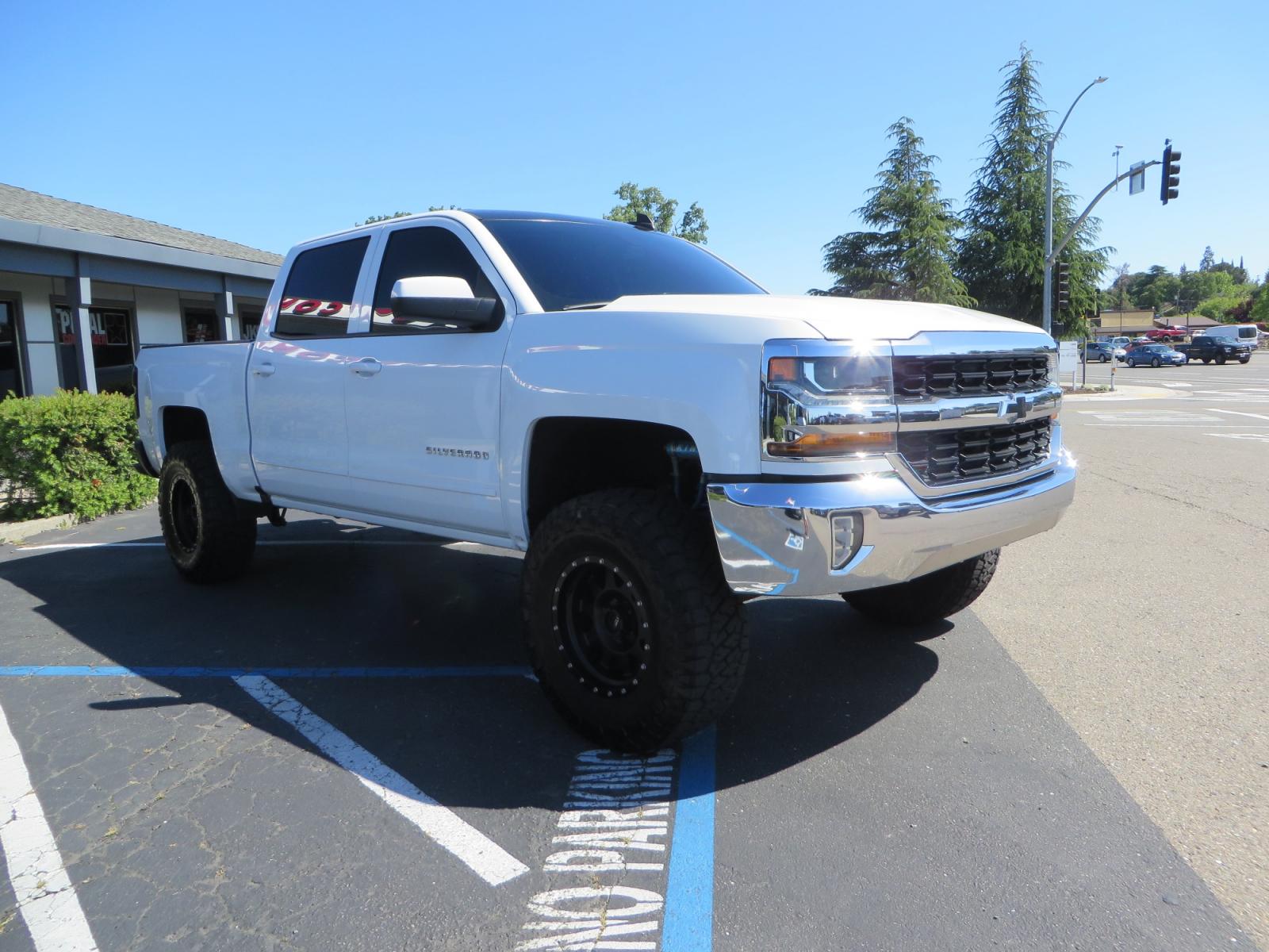 2018 White /BLACK Chevrolet Silverado 1500 LT (3GCPCREC7JG) with an 5.3L V8 OHV 16V engine, automatic transmission, located at 2630 Grass Valley Highway, Auburn, CA, 95603, (530) 508-5100, 38.937893, -121.095482 - Must see Pre Runner.... CST front lift spindals, Camburg UCA's, King Adjustable 2.5 Coil-overs, King 2.5 rear shocks, 35" Toyo RT Trail tires, 17" Method Race wheels, MZ front skid plate, G2 rear differntail cover, Full size bed mounted spare tire, Black Vinyl roof wrap, smoke tail lights and 3rd br - Photo #2